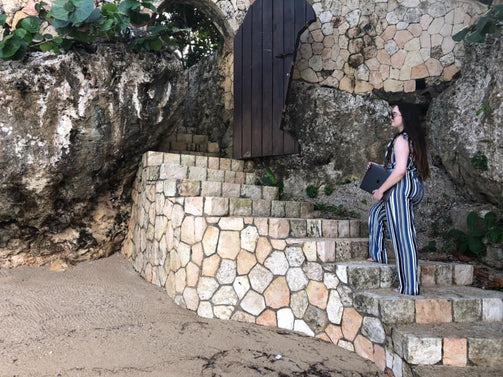 Chel on stairs with MacBook Pro in Jamaica 